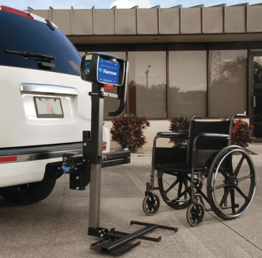 Manual wheelchair beside manual vehicle lift