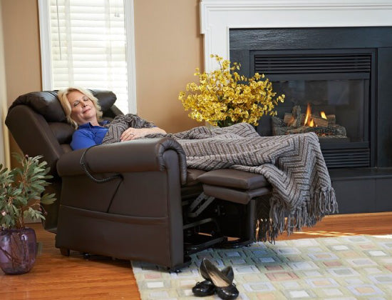 Woman relaxing on lift chair recliner by fireplace