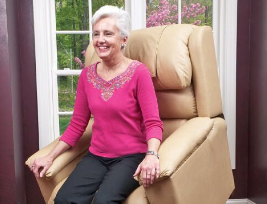 Elderly woman sitting on beige lift chair